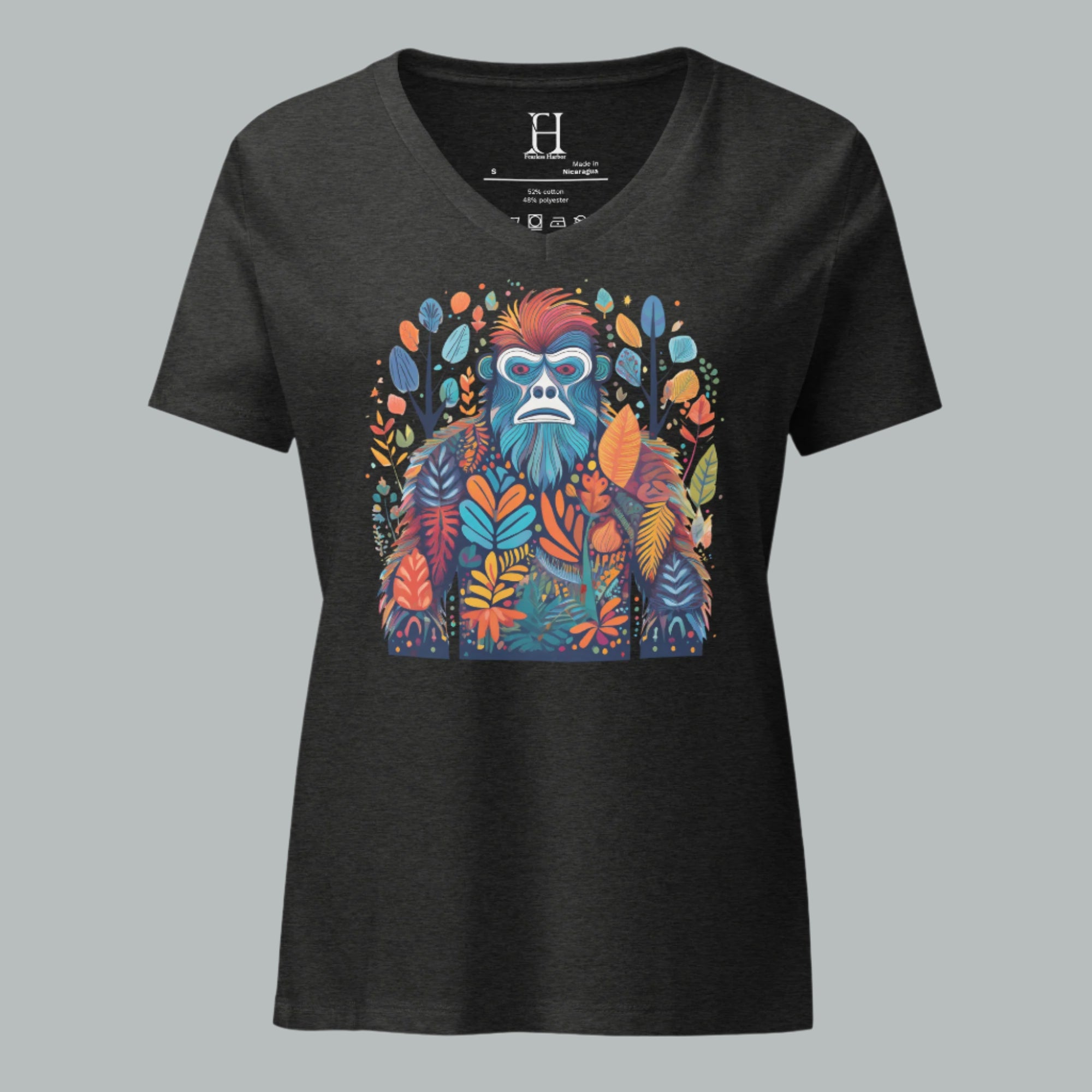 Front of women’s V-neck tee in dark grey heather featuring a colorful Bigfoot design blending into tree shapes.
