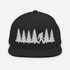 Front view of black trucker hat featuring a white embroidered Bigfoot silhouette walking through pine trees.
