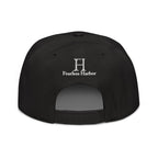 Back of Buck Snapback Hat in black, with white embroidered FH logo.