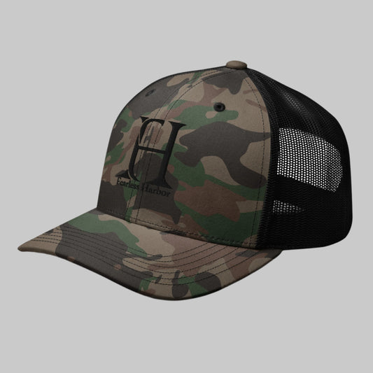 Left Front of Fearless Harbor Camouflage Trucker Hat in Camo Black with FH logo and the words Fearless Harbor.