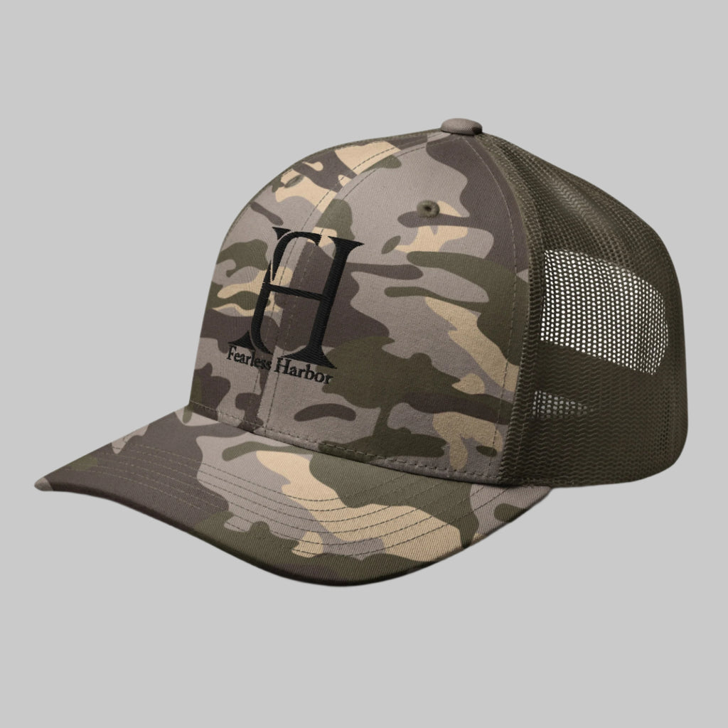 Left Front of Fearless Harbor Camouflage Trucker Hat in Camo Olive with FH logo and the words Fearless Harbor.