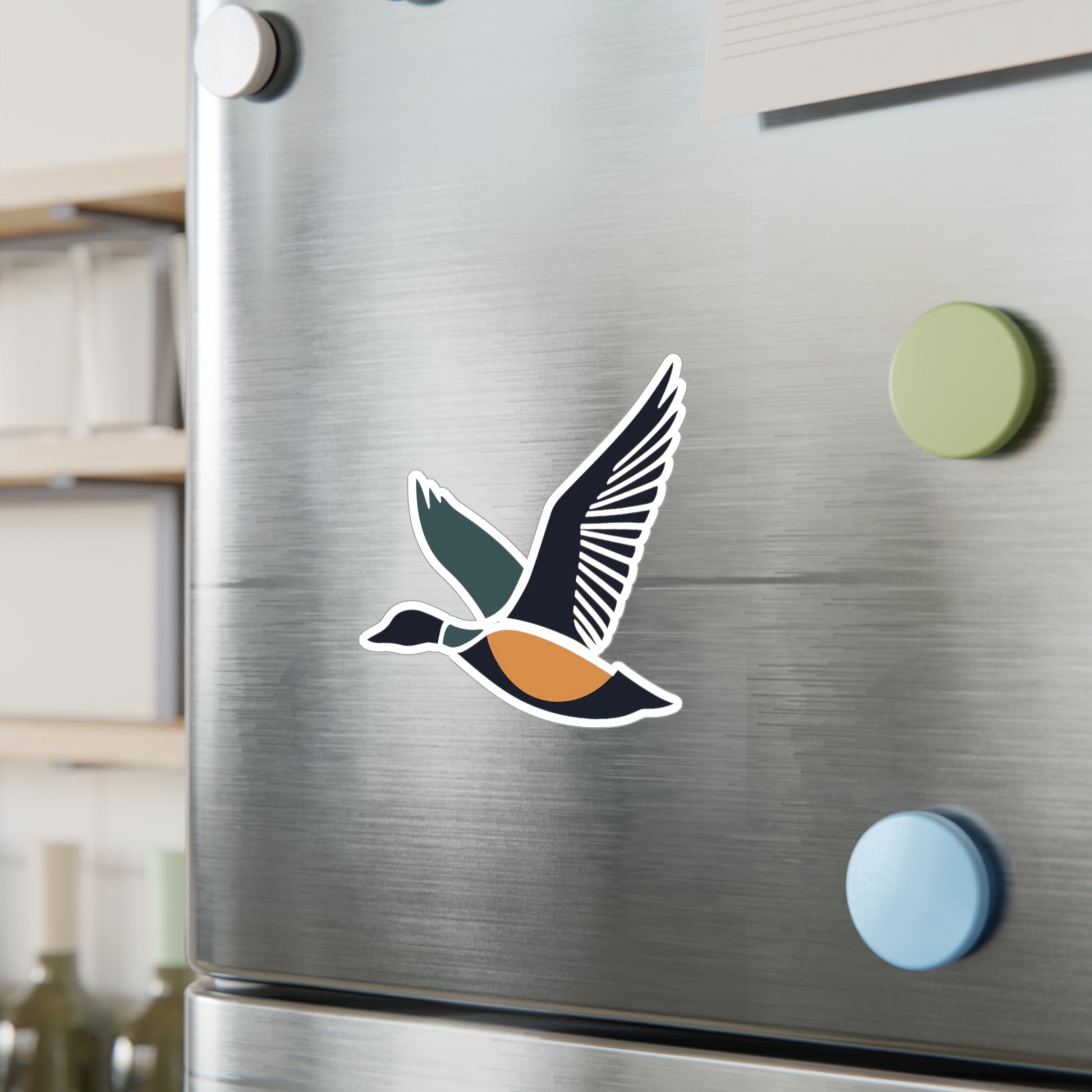 Flying Duck Vinyl Sticker displayed on a refrigerator. 