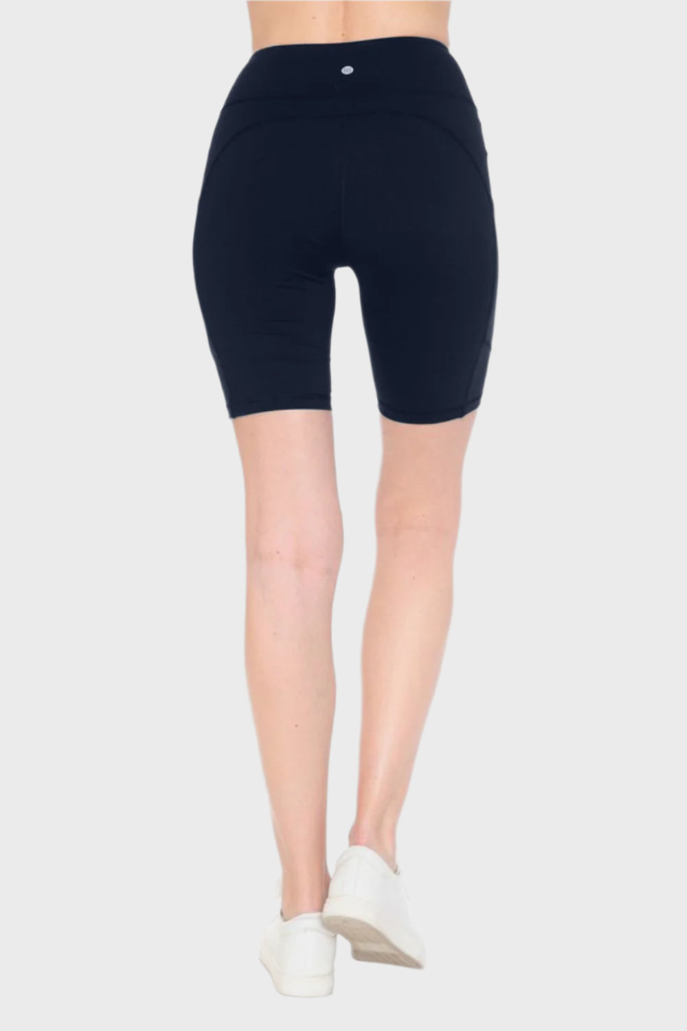 Back of woman wearing Full Size High Waist Active Shorts in Navy, blank with no graphics or text.