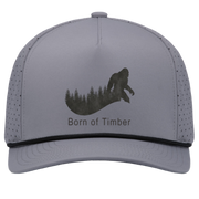 Front view of graphite and black bigfoot hunting snapback cap featuring walking sasquatch silhouette over pine forest line.
