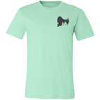 Front view of the Men’s He Was Here First Bigfoot Hunting Tee in Heather Mint showing a small Bigfoot silhouette chest graphic with pine trees and Born of Timber text.