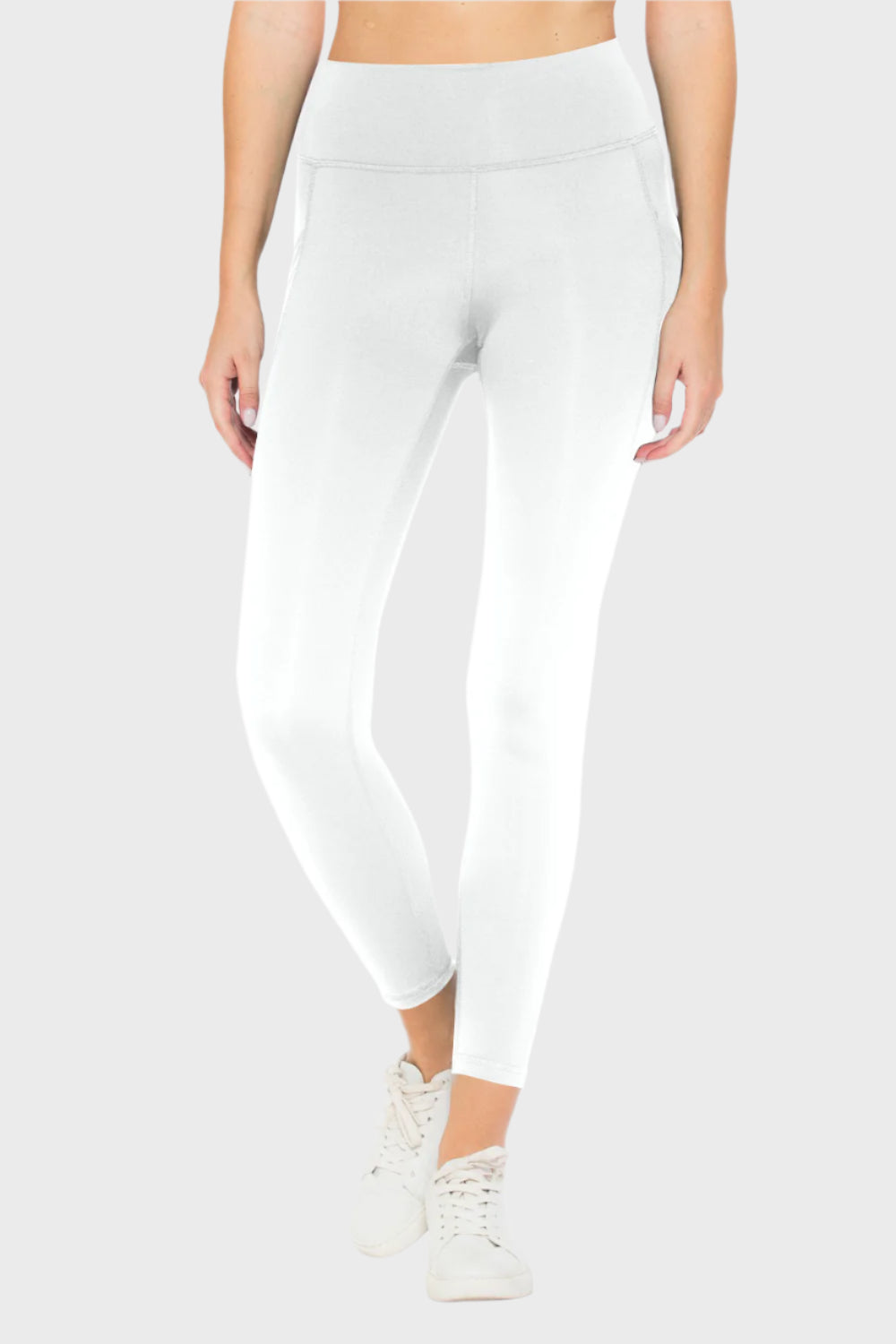 Front of woman wearing High Waist Leggings with Pockets in White, blank with no graphics or text.