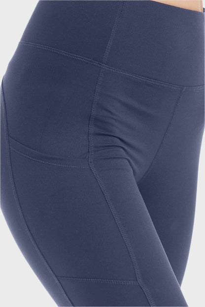 Front of woman wearing High Waist Wide Waistband Leggings in Ink Blue, blank with no graphics or text.