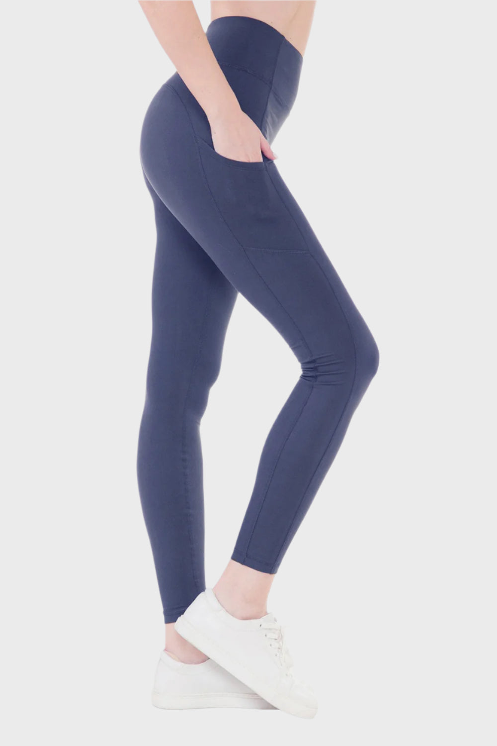 Right Side of High Waist Wide Waistband Leggings in Ink Blue, woman placing hand in pocket blank with no graphics or text. 