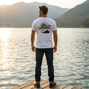 Men wearing the Expected Ducks, Got Sail duck hunting graphic tee in Solid White Blend showing the sail backed dinosaur graphic in a waterfowl setting