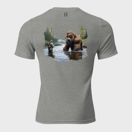 Back of Bigfoot Big Catch T-shirt in Grey with design of a fisherman and hook caught on Bigfoot sitting in lake.