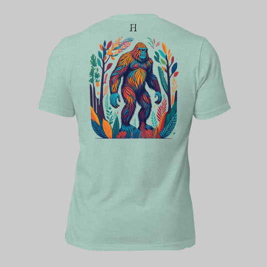 Back of Camo Challenge T-Shirt in Dusty Blue, Multicolored Bigfoot design, with FH logo near collar.