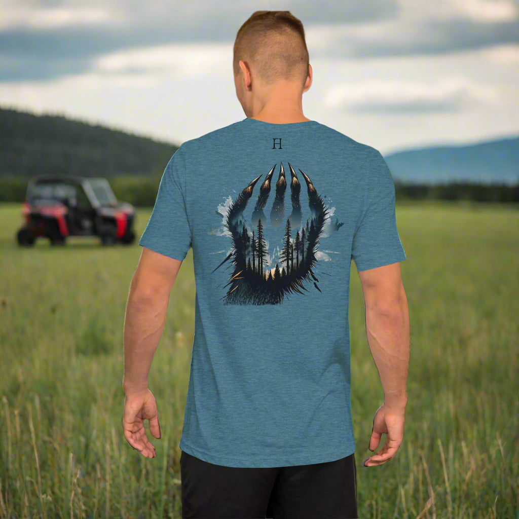 Back of Man wearing Clawed Through Wild T-shirt in Teal with Wildlife Claw Design.