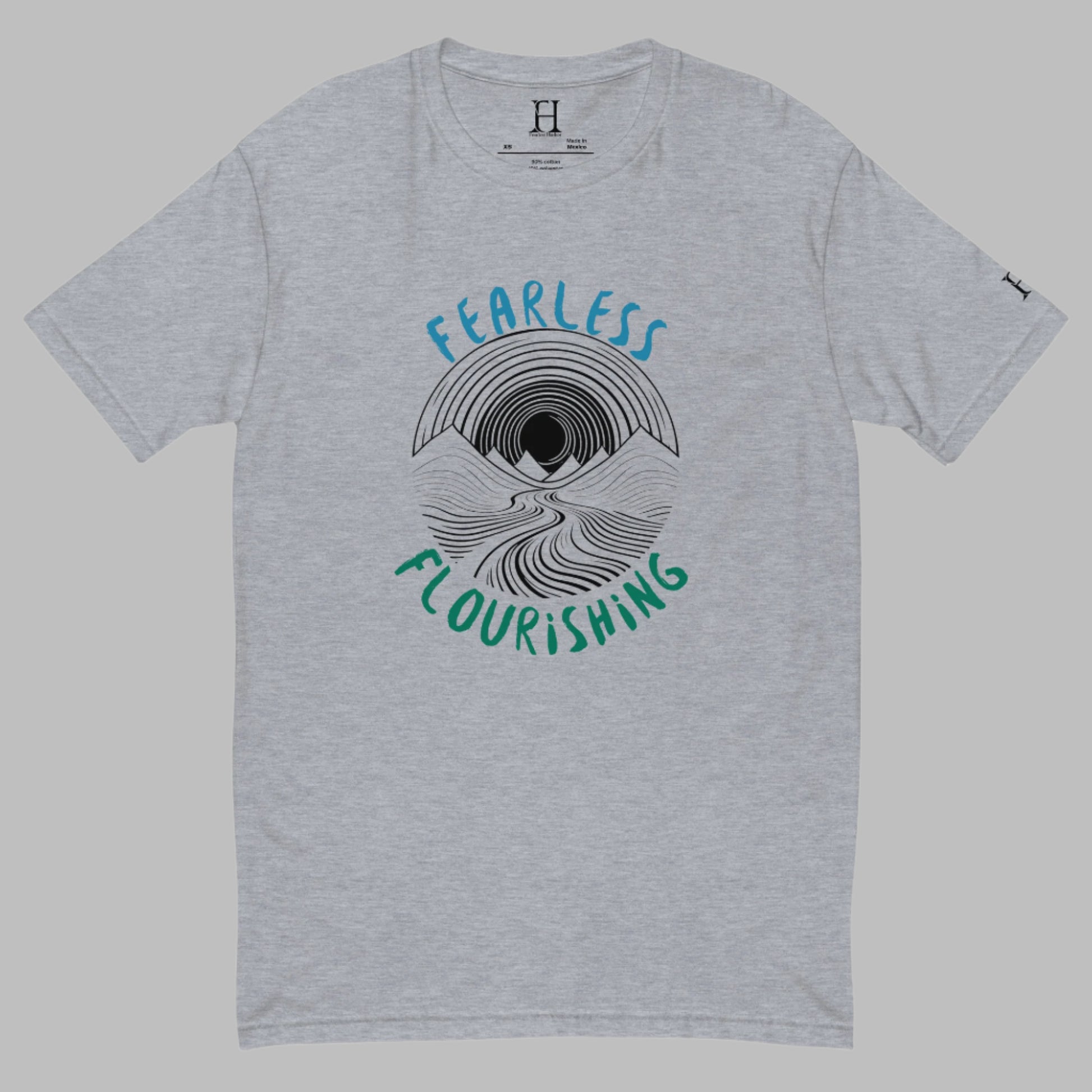 Front of grey T-shirt with black outline of a river flowing through mountains and the words Fearless and Flourishing.