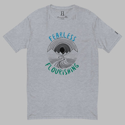 Front of grey T-shirt with black outline of a river flowing through mountains and the words Fearless and Flourishing.