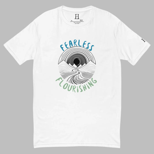 Front of white T-shirt with black outline of a river flowing through mountains and the words Fearless and Flourishing.