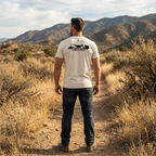 Mens turkey hunting graphic tee worn by public land hunter back view in Oatmeal showing raptor and turkey lineage graphic