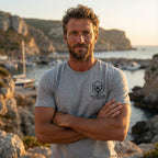 Athletic grey premium elk hunting graphic tee worn outdoors showing small Fearless Harbor chest logo.