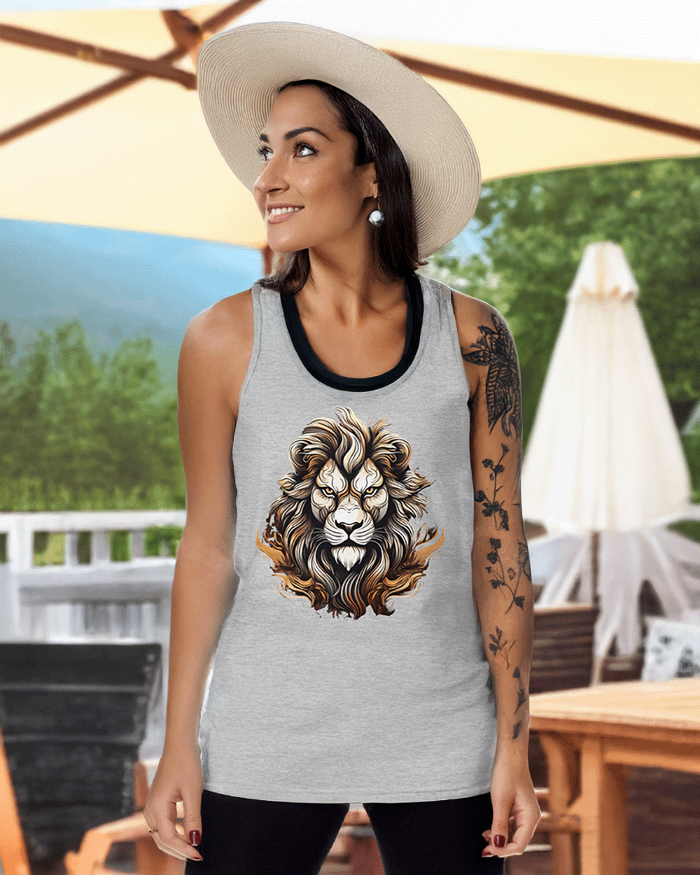 A woman in a sun hat wears the athletic heather Alpha Strength tank at a summer BBQ, embodying bold calm and power.