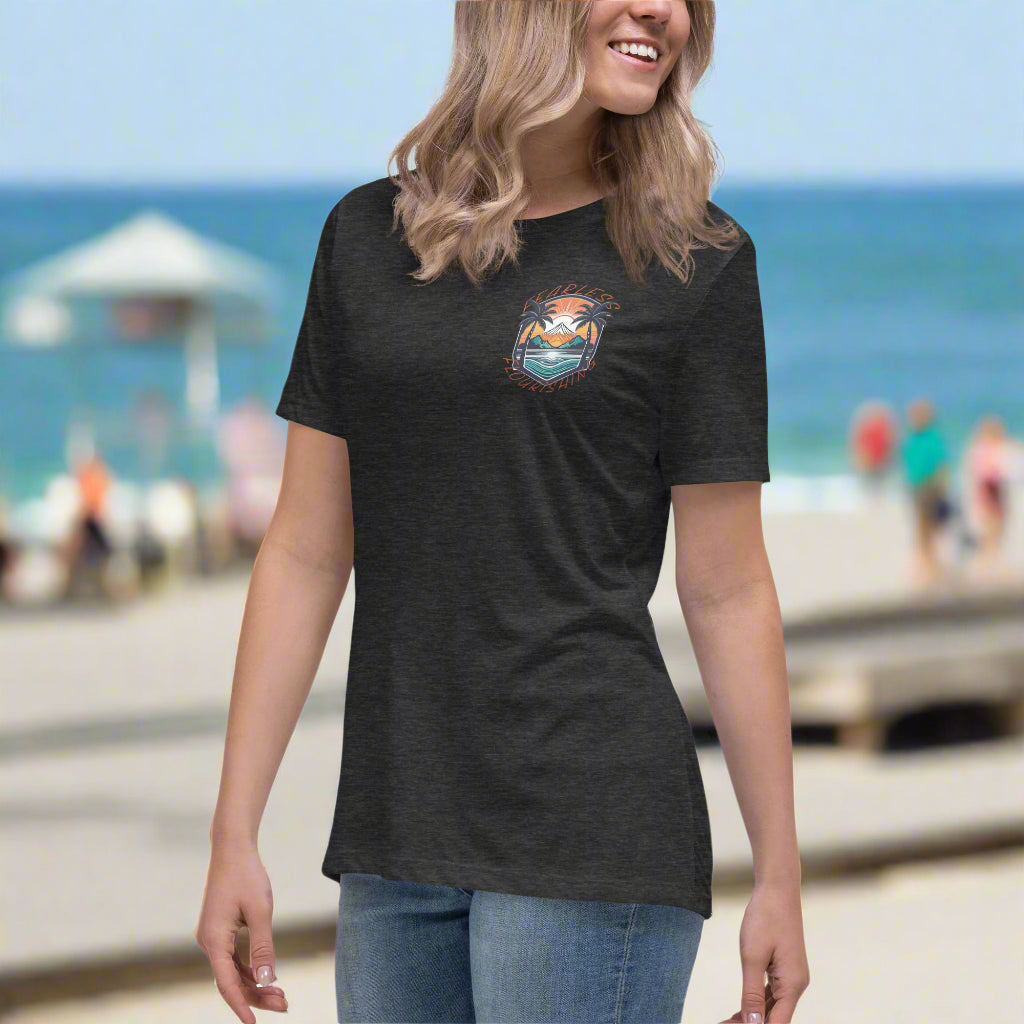 Front of Woman wearing Beach Emblem Relaxed T-Shirt in Dark Grey, with Beach logo on top left and words Fearless Flourishing.