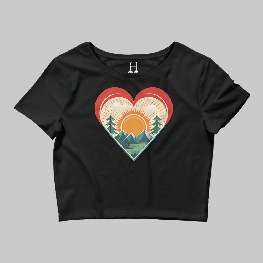 Front of Bold Crop Top Tee in Black, with sun rising over a forest within a heart silhouette design.