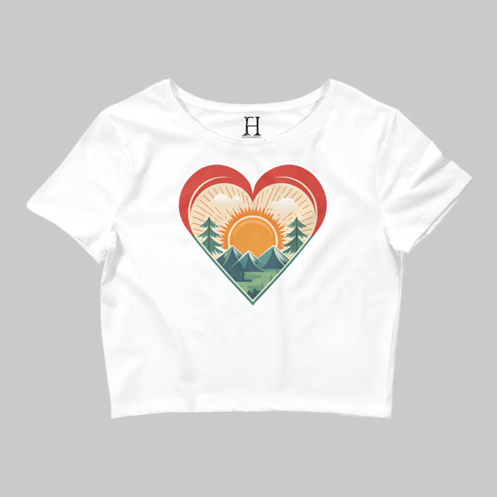 Front of Bold Crop Top Tee in White, with sun rising over a forest within a heart silhouette design.