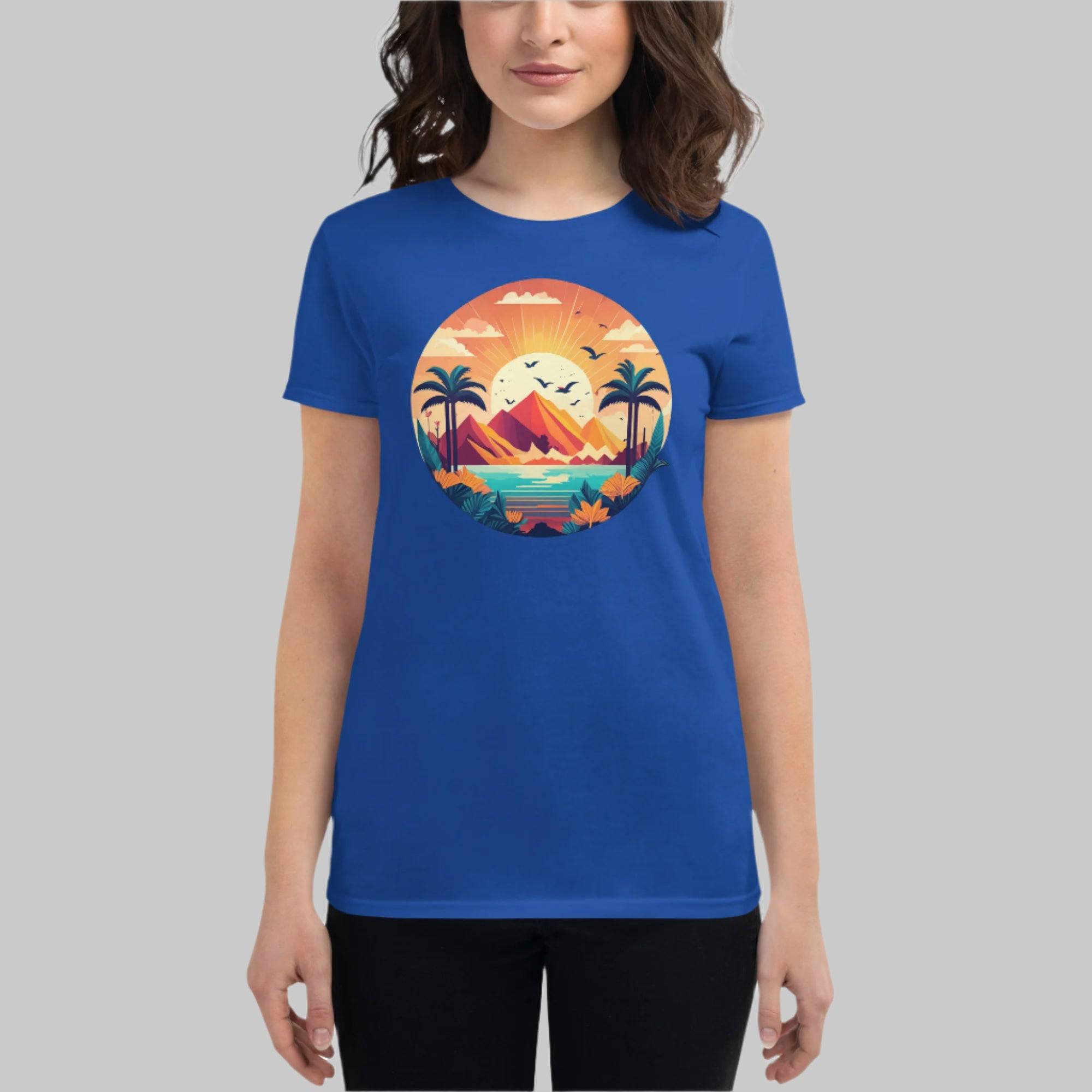 Front of Woman wearing Fearless Flourishing T-Shirt in Blue with beautiful harbor, surrounded by trees and mountains design.