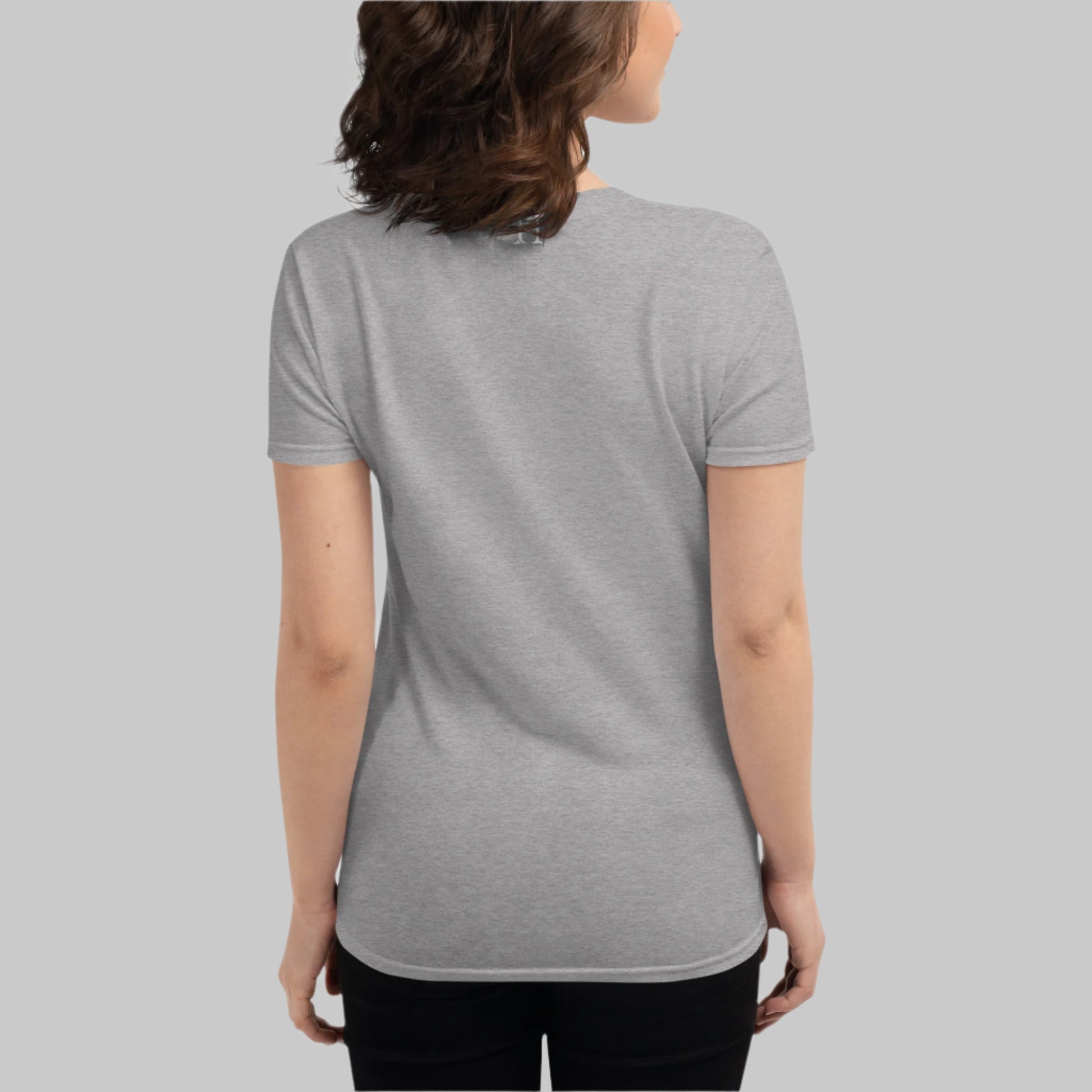 Back of Woman wearing Fearless Growth T-Shirt in Black, with FH log at top near the color in white.