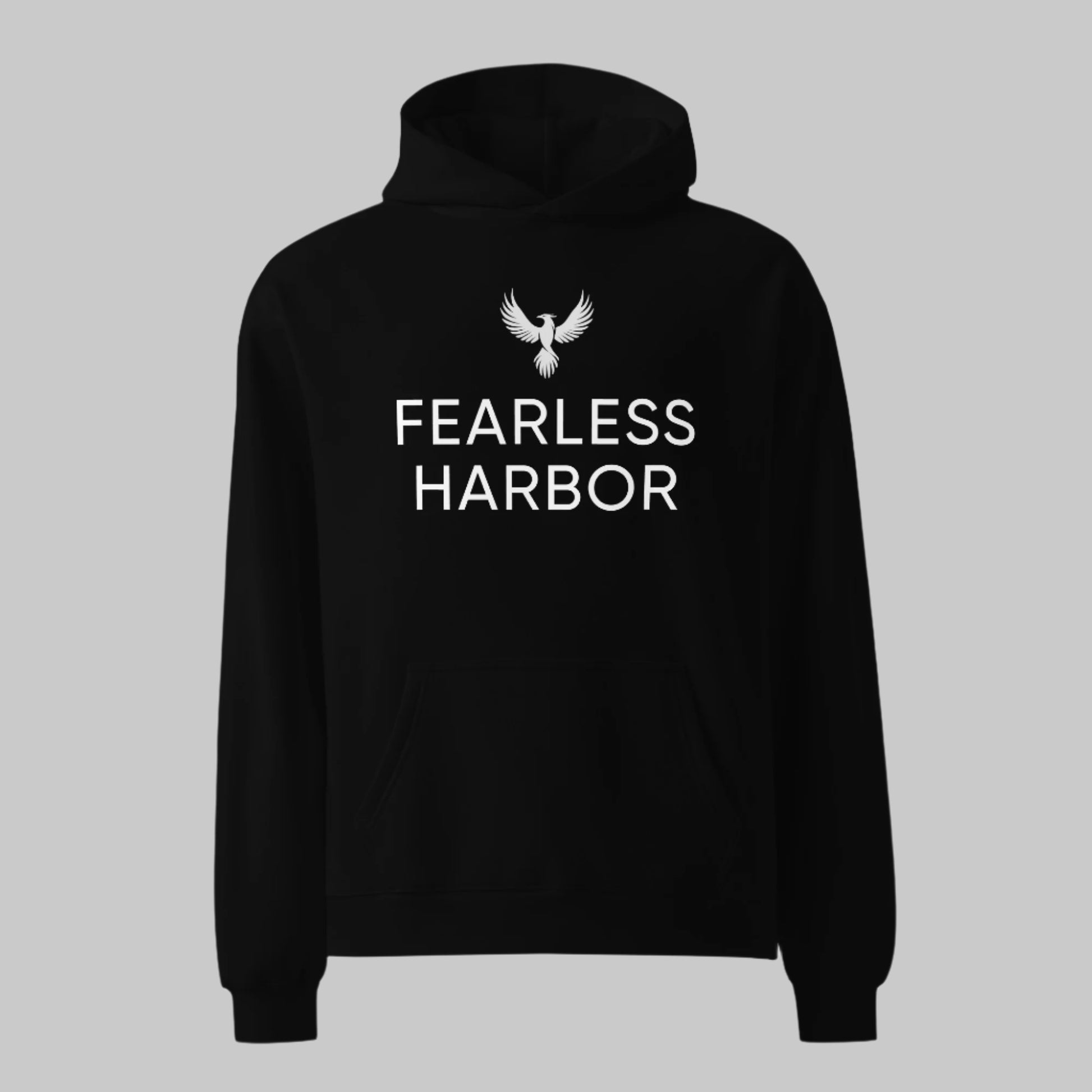 Front of Woman wearing Fearless Harbor Oversized Hoodie in Black, with Phoenix Logo above the text Fearless Harbor in white.