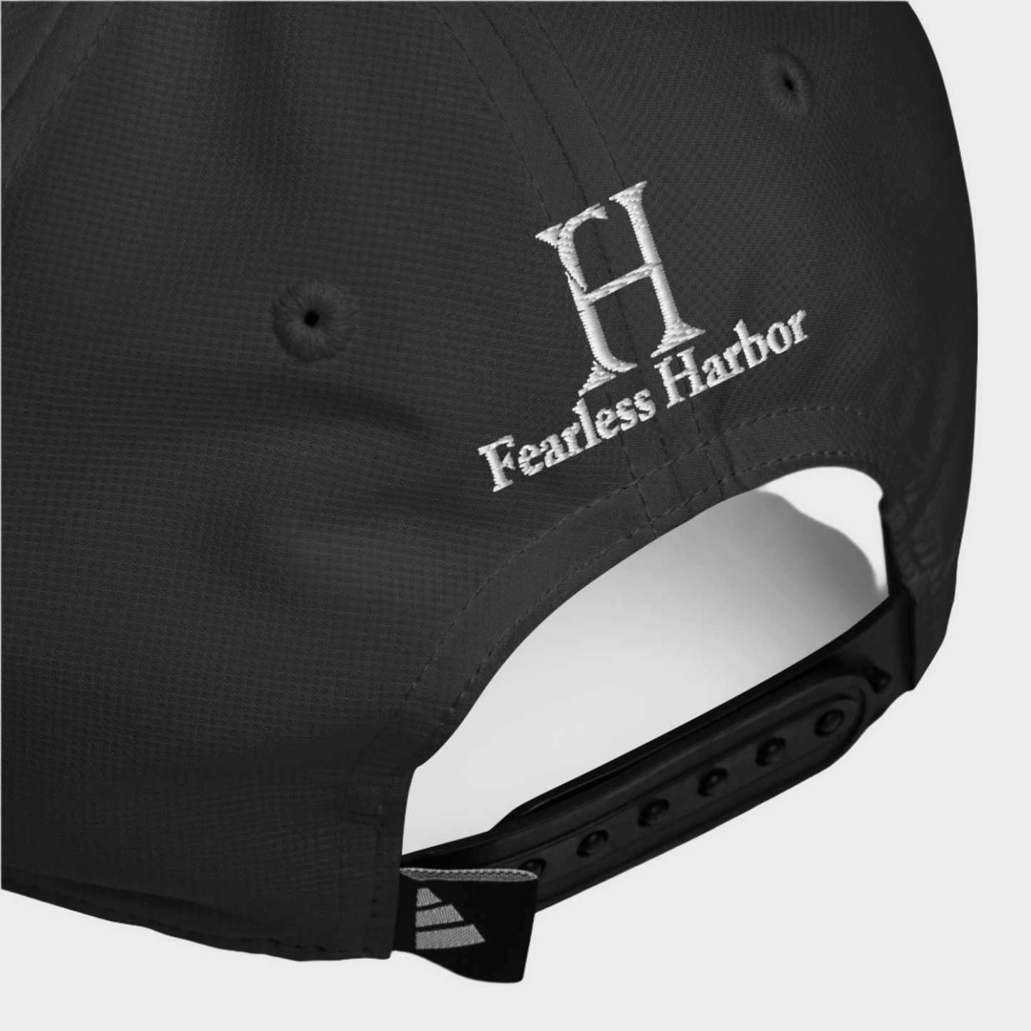 Back of Phoenix Performance Hat in Black, with black snap enclosure, and white embroidered FH logo.