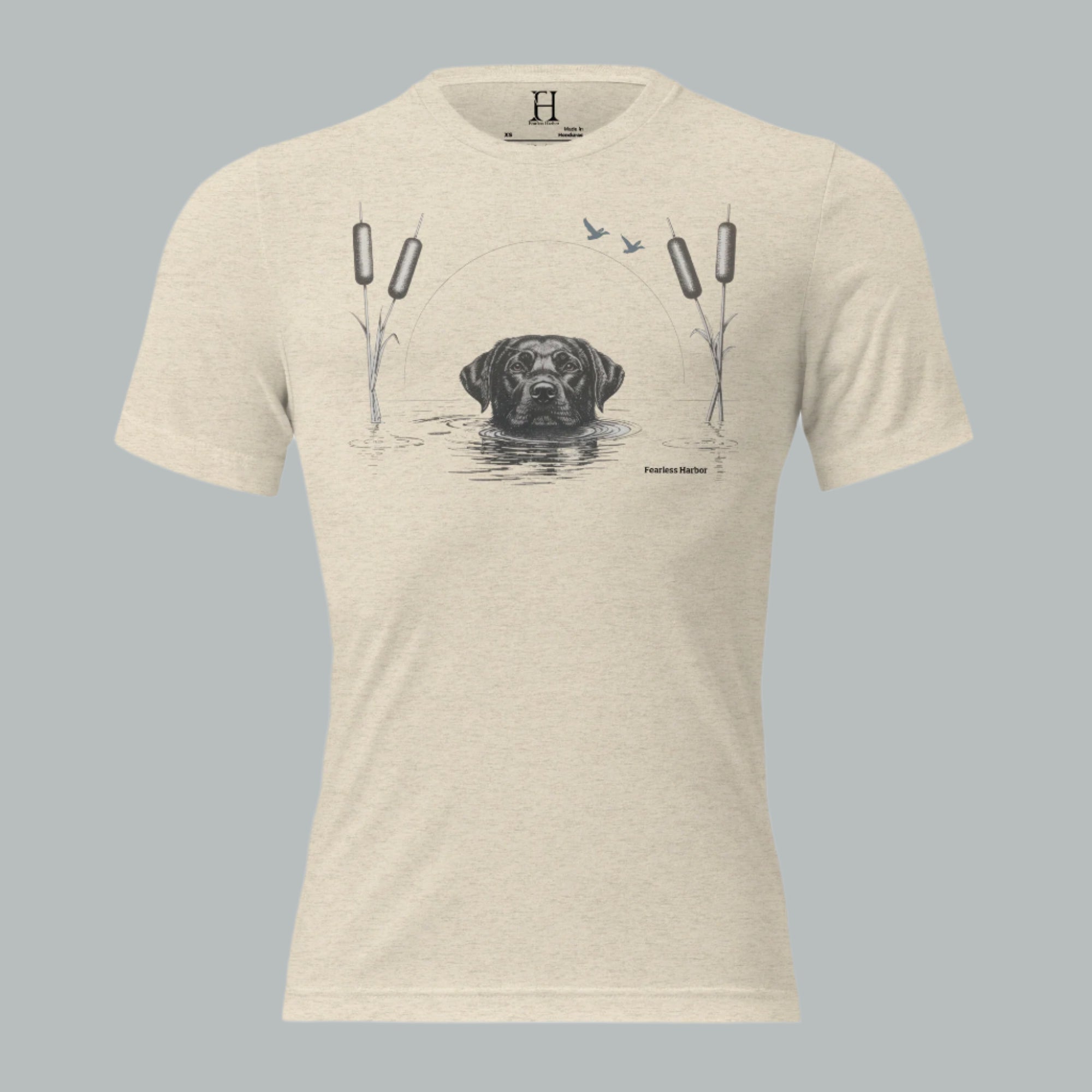 Front view of Fearless Harbor Men’s Black Lab Wetlands Tee in oatmeal with hunting lab, reeds, and ducks graphic