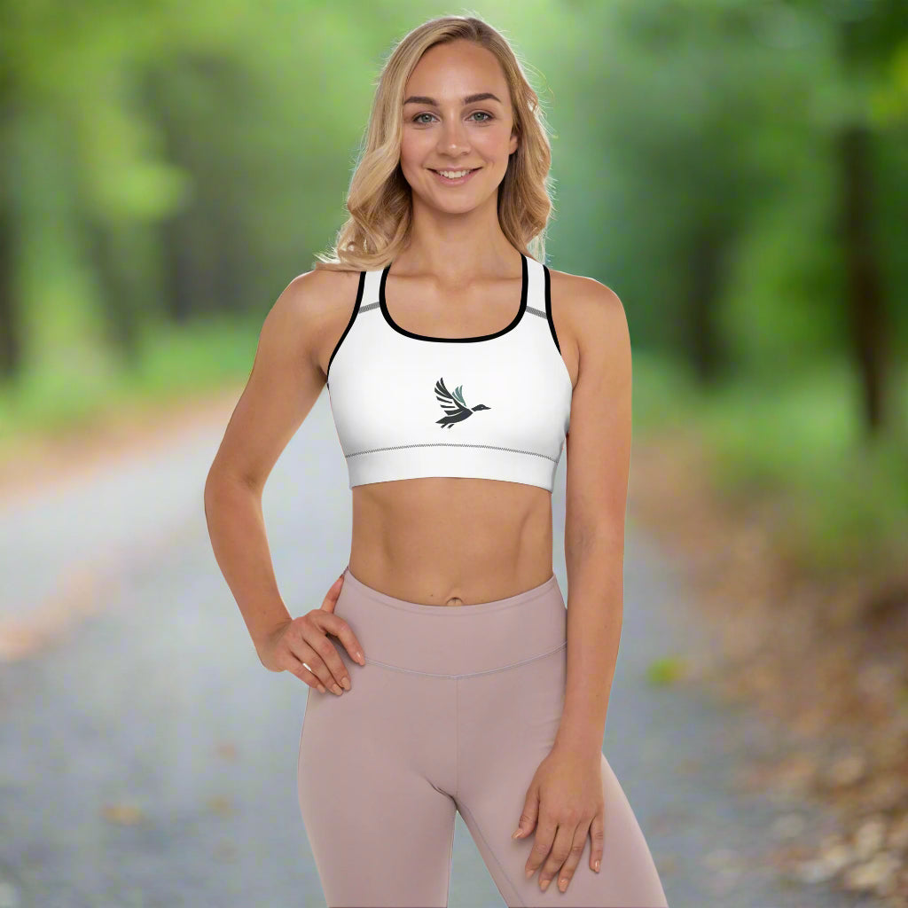 Front view of a woman wearing Fearless Harbor Shadowed Flight Padded Sports Bra in White with black trim and duck graphic.