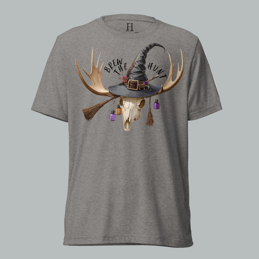 Front view of Fearless Harbor Women's Brew the Hunt Tee in Grey, featuring skull with antlers, witch hat, and broomstick design.