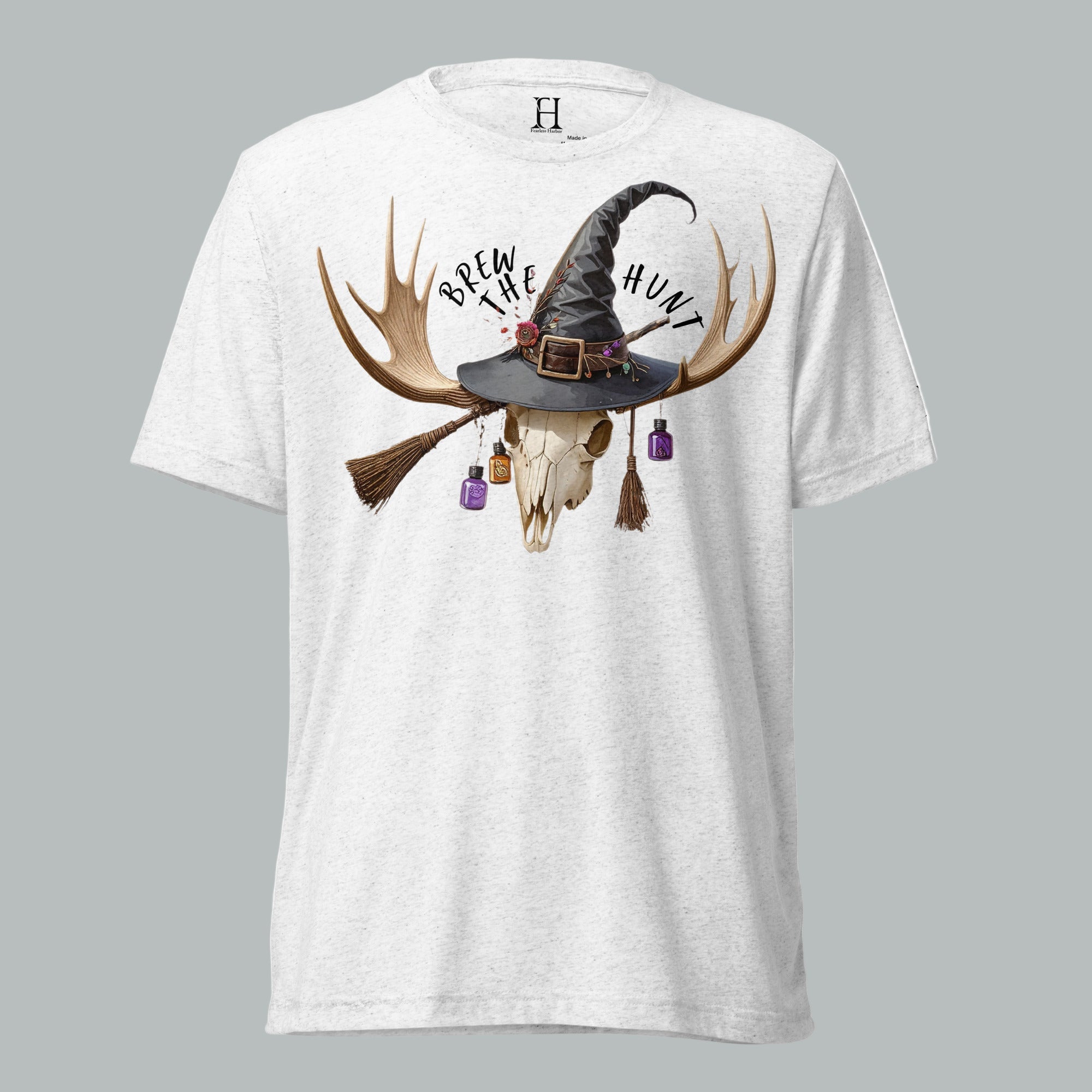 Front view of Fearless Harbor Women's Brew the Hunt Tee in White, featuring skull with antlers, witch hat, and broomstick design.