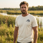 Man outdoors wearing the Men's Drift Line Goose Tee in Heather Dust front view with Public Marsh chest emblem