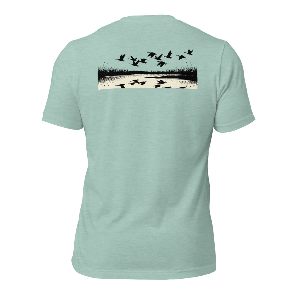 Men's Drift Line Goose Tee in Heather Prism Dusty Blue showing geese drifting over marsh horizon with mirrored reflections