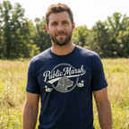 Man outdoors wearing a mens heather navy duck hunting shirt with Public Marsh retriever and duck design