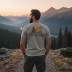 Man outdoors wearing the Men's First Light Crew Waterfowl Tee in Grey Triblend showing hunter, retriever and ducks artwork