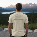 Man outdoors wearing the Men's Migration Lines Goose Tee in Oatmeal Triblend showing migrating geese line-art graphic on the back