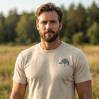 Man outdoors wearing the Men's Migration Lines Goose Tee in Oatmeal Triblend front view with Public Marsh emblem